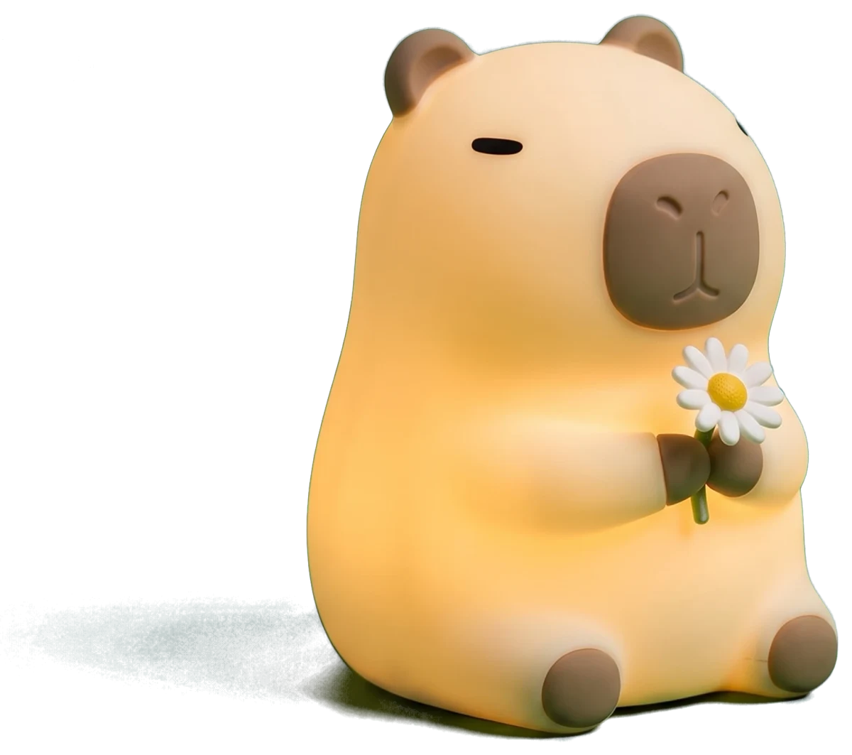 Soft silicone capybara night light holding a flower, glowing warm in a dark room